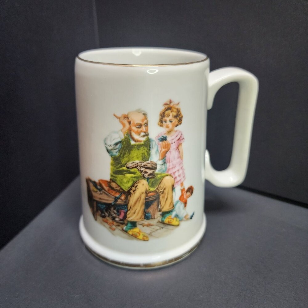 Norman Rockwell Museum - The Cobbler - Coffee Tea Mug Cup White w/ Gold Rim